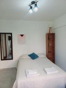 um quarto com uma cama com duas toalhas em Hermoso monoambiente en ciudad de Mendoza. em Mendoza