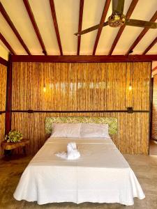 a bedroom with a bed with a towel on it at Finca en Doradal ( Hacienda Napoles y Rio Claro ) in Doradal