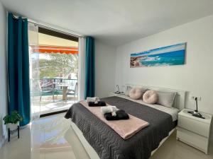 a bedroom with a bed and a large window at Royal View Apartment - Los Cristianos in Los Cristianos