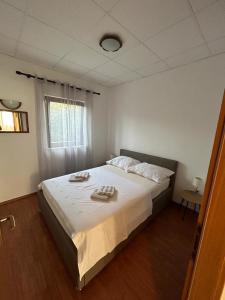a bedroom with a bed with two towels on it at Apartments by the sea Slatine, Ciovo - 1128 in Slatine