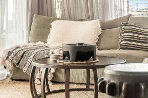 a living room with a couch and a table at Sophie's Place ReLaunch - Luxury Penthouse in Byron Bay