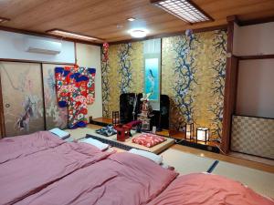 a bedroom with a bed and a wall with curtains at Morita-ya Japanese style inn KingyoーVacation STAY 62437 in Tamana