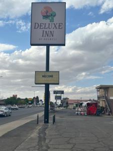 a sign for a deluce inn on a street at Deluxe Inn Of Roswell in Roswell