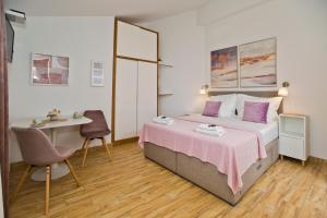 a bedroom with a bed and a desk and a table at Apartments by the sea Hvar - 10430 in Hvar