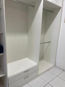 a white walk in closet with white cabinets at Apto 3 otimo Local próximo Shopping in Campo Grande