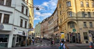 uma rua da cidade com edifícios e pessoas a andar de bicicleta em The Place to be 2 "City Centre Apartments" em Viena