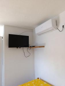 TV de pantalla plana en la pared de una habitación en Apartments Eftimov en Tivat