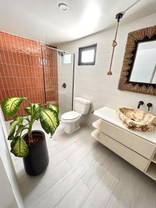聖胡安的住宿－Bali Poshtel PR，一间带卫生间和植物的浴室