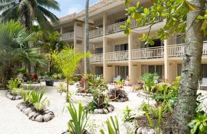 an exterior view of a resort with plants and trees at The Edgewater Resort & Spa in Rarotonga