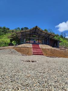 a stage on a beach with a red carpet at Glamping La Mardo in Cartago