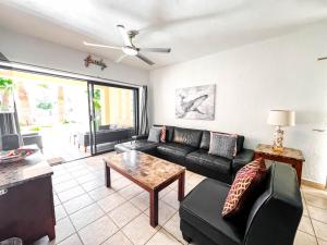 a living room with a couch and a table at Sandy Beach Princesa D101 Ocean Front Resort in Puerto Peñasco