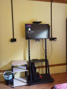 a flat screen tv on a stand in a room at Permata Beach Chalet in Kampong Juara