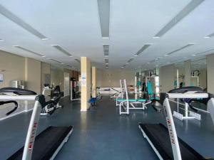 a gym with several treadmills and machines in it at Porto Real Resorts - Apartamento com Vista in Mangaratiba