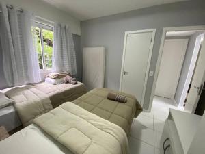 a living room with two beds and a couch at Porto Real Resorts - Apartamento com Vista in Mangaratiba +23 photos