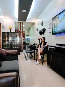 a woman sitting on a chair in a salon at SNOW Transient - Near Clark Airport, Dinosaurs Island, Aqua Planet in Mabalacat