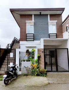 a motorcycle parked in front of a house at SNOW Transient - Near Clark Airport, Dinosaurs Island, Aqua Planet in Mabalacat