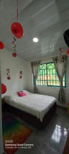 a bedroom with a bed in a room with red decorations at Casa campestre Villa sofia in Utica
