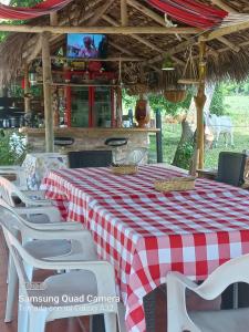 a table and chairs with a red and white checkered table cloth at Casa campestre Villa sofia in Utica