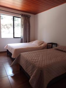 Postel nebo postele na pokoji v ubytování casa de campo la fresita