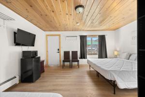 a bedroom with a bed and a flat screen tv at Lift Landing in Idaho Springs