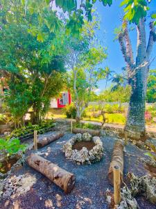 a garden with logs and a fire pit at Tiny House's Seafront Room in Camotes Island in Esperanza
