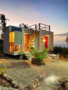 a house with a staircase in the front of it at Tiny House's Seafront Room in Camotes Island in Esperanza
