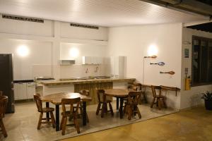 a kitchen with wooden tables and chairs in it at Cruz Roja - Turismo Solimões in Leticia