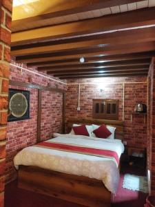 a brick bedroom with a bed in a brick wall at HOTEL RUPAKOT AND ROOFTOP RESTAURANT in Bhaktapur +195 photos