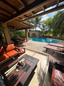 a patio with a table and chairs and a pool at VILLA EN MORROCOY in Tucacas