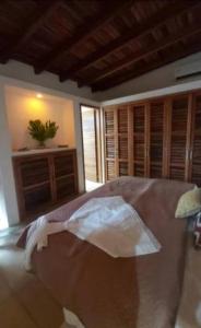 a bedroom with a bed and wooden cabinets at VILLA EN MORROCOY in Tucacas