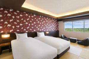 a hotel room with two beds and a window at Grand Mercure Okinawa Cape Zanpa Resort in Yomitan