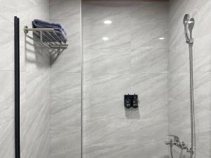 a shower with a glass door in a bathroom at 本氣宿泊Honkiya in Hengchun