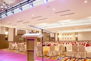 a conference room with rows of chairs and a podium at Arena Premier Hotel in Seremban