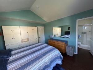 a bedroom with a large bed and a bathroom at Garys Place in Santa Rosa