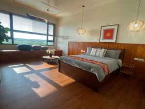 a bedroom with a bed and a large window at 本氣宿泊Honkiya in Hengchun