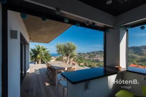a balcony with a table and a view of the ocean at Villa Blanca 5 Sea View and Mountain in Banyuls-sur-Mer