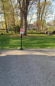 a sign on the side of a road in a park at Cozy 2nd Floor Apartment With Private Entrance in Chicopee