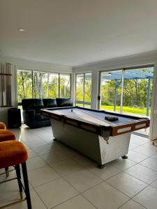 a living room with a pool table in it at Hinterland Heights in Canungra +96 photos