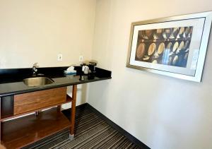 a bathroom with a sink and a picture on the wall at Motel 6 Martinez, CA in Martinez