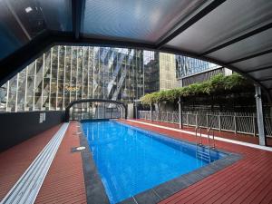 a swimming pool on the roof of a building at Generous 2br2ba Docklands Free Parkingpool in Melbourne