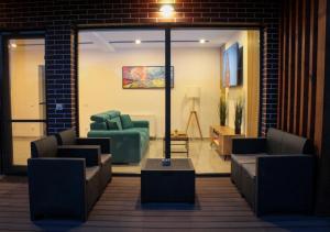 a lobby with couches and chairs in a room at NOVA House Apartments in Delniţa