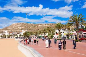 a group of people walking on the beach at Traditional apartment in the center of Agadir in Agadir
