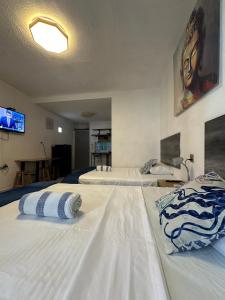 2 camas blancas grandes en una habitación en Suites Brisa Marina - Playa Regatas y Malecón, en Veracruz