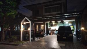 a car parked outside of a store at night at Friend's House in Bangkok