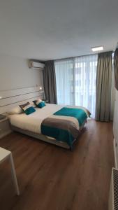 Ein Bett oder Betten in einem Zimmer der Unterkunft Apart Lyon Suite