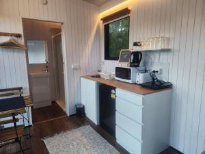a kitchen with a counter with a microwave on it at The Fog Getaway by Tiny Away in Boolambayte +13 photos