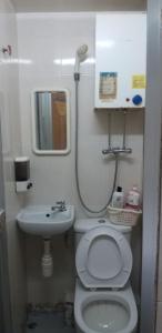 La petite salle de bains est pourvue de toilettes et d'un lavabo. dans l'établissement NEW WASHINGTON GUEST HOUSE B1,B2 B LOCK 13 FLOOR CHUNG KING MANSHION, 36-44 NATHAN ROAD KOWLOON HONG KONG, à Hong Kong