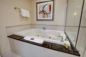 a bathroom with a bath tub with a glass shower at MGM Studio Suite with POOL VIEW Tower 1 in Las Vegas