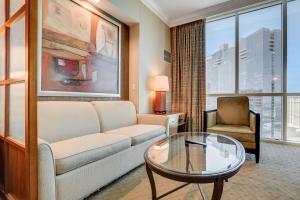 a living room with a couch and a glass table at MGM Studio Suite with POOL VIEW Tower 1 in Las Vegas