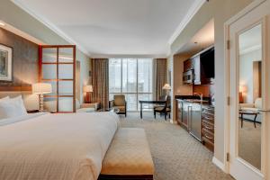 a hotel room with a large bed and a living room at MGM Studio Suite with POOL VIEW Tower 1 in Las Vegas